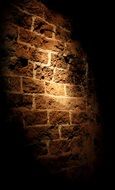 lighting on a brick wall close up