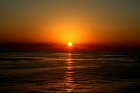 golden streak of the evening sun on the surface of the ocean