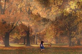 little girl walking in autumn forest