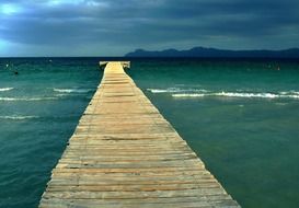 long wooden pier to the mediterranean sea in majorca