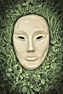 white mask on the grass mystical