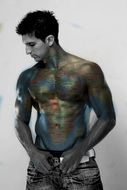 Monochrome picture of the man in the colored tattoo