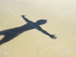 man shadow on sand