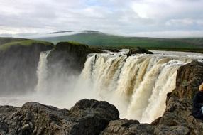 panorama of a rocky waterfall in iceland