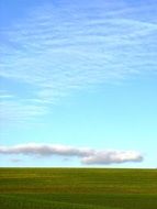 big white cloud over green field