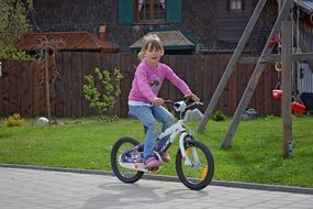 girl rides a bicycle in the countryside
