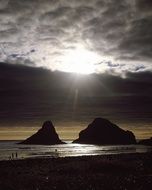 silhouettes of people on the evening coast, Oregon