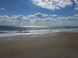 Beautiful beach in light under blue sky with white clouds