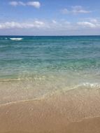 Beautiful sandy beach with colorful and gradient water