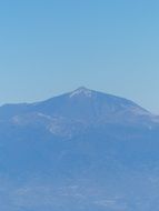 distant view of a volcano in blue background