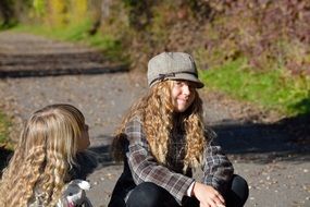 girl s with curly hairs on sunny road