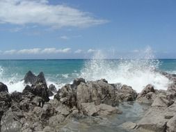 seawater splashes on the stone beach