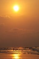 waves under the orange sun