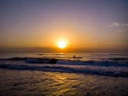 A man in a boat at sunset