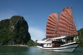ship with sails in the gulf in vietnam