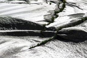 stones on a glacier in the alps in black and white image