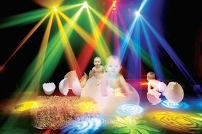 little children in colored rays of light