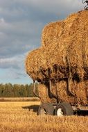 pile of hay stacks on truck in countryside, finland