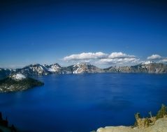 panorama of bright blue crater lake in oregon