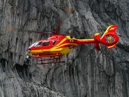 rescue helicopter on a background of rocks