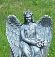 angel sculpture on the background of the lawn