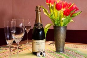 tulips, glasses, rabbit figurines and champagne cremant de loire marqis de neausei brut