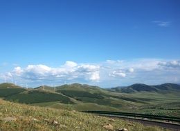 green meadows and windmills in the mountains