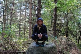 girl on stone in the forest