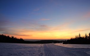 sunset on the snowy road