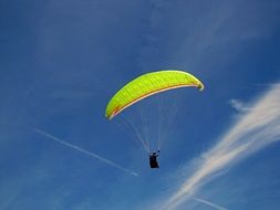 colorful paraglider in the blue sky