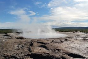 vapour above geyser in wilderness, iceland