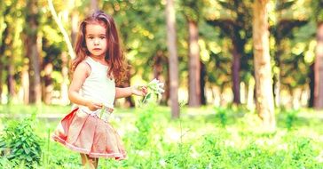 little girl standing on green grass