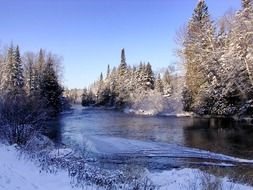 Beautiful Namekagon river among the plants in the snow in Wisconsin