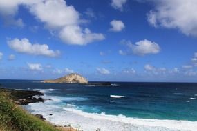 blue sky with white clouds on the shoreline in Hawaii