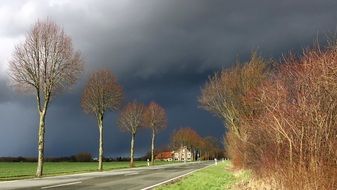 road under thunder clouds