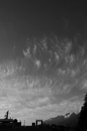 black white photo of cloudy sky over the mountains