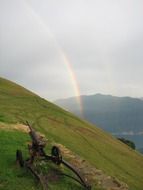 Beautiful and colorful double rainbow above the hill on landscape