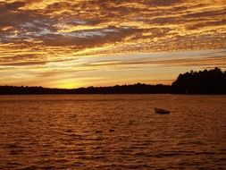golden sunset in the clouds over the lake