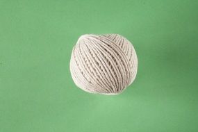 knitting rope on green surface