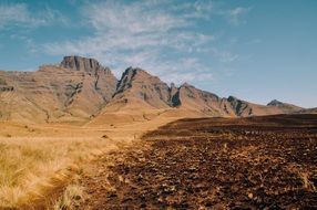 plowed land on a background of mountains