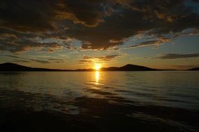 sea, mountains, clouds at sunset