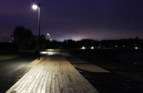 walk on the boardwalk illuminated by night lights