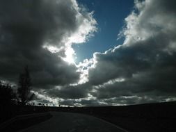 sunlight behind big clouds