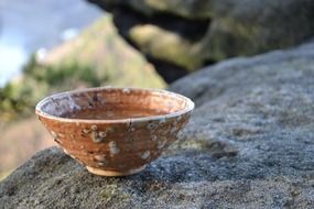 rustic pottery bowl on stone