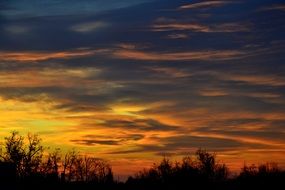 dark clouds in orange afterglow during dawn