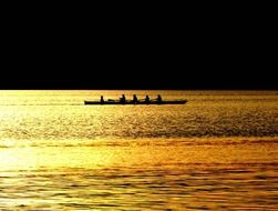 rowing boat on the sea at night