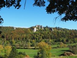 Distant view of the castle ruins on the rock among the colorful plants in Baden WÃ¼rttemberg