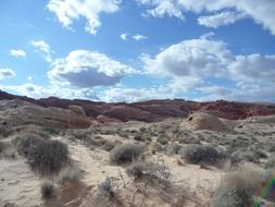 landscape of clouds over sand dunes