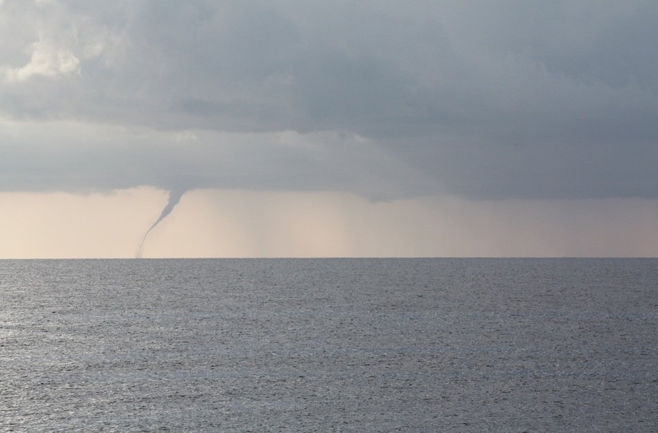 Tornado and cloudy sky over the water