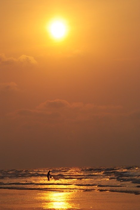 waves under the orange sun
